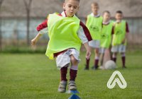 Young boy playing football Amaven 