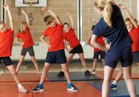 Young Children Stretching in Gym Class