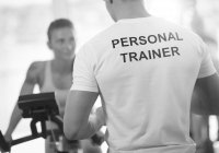 Personal Trainer training client on an exercise bike