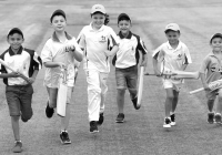 Six young boys running while holding cricket bats