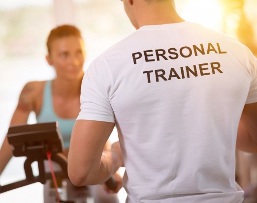 Personal Trainer training client on an exercise bike