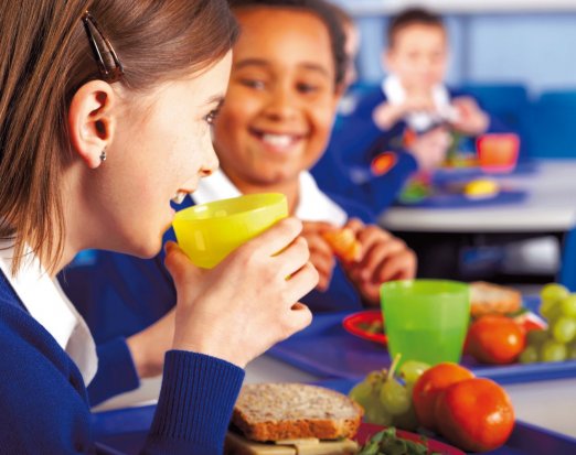 Two Young People Eating a Healthy School Lunch