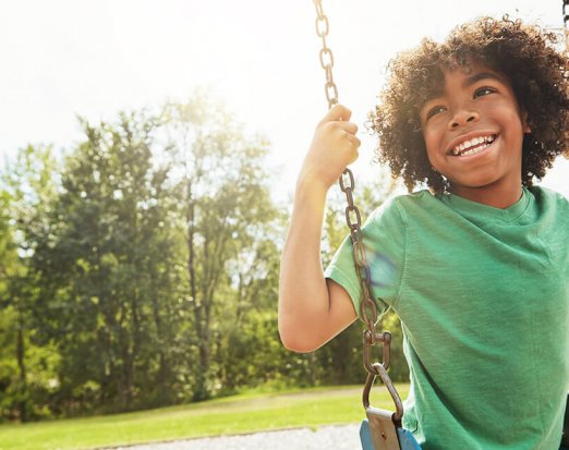 Young Boy Sitting on a Swing