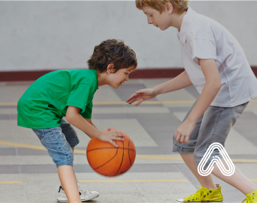 Young children playing basket ball