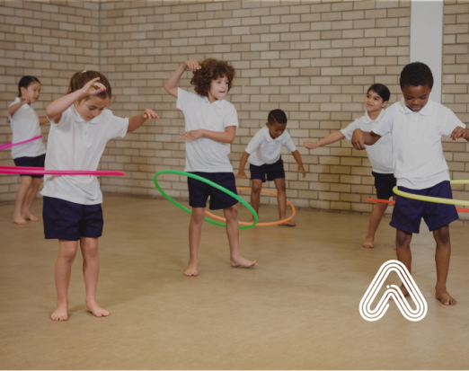 Kids playing with hula hoops in school