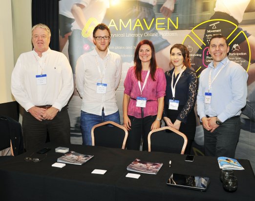 members of Amaven standing at conference 