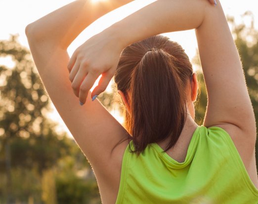 Woman stretching in the sunshine