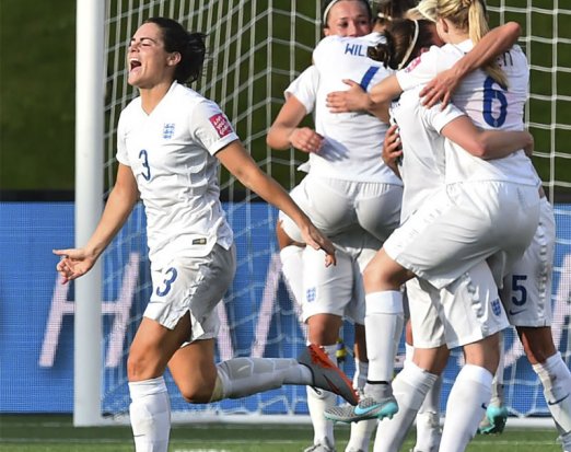 Women's football team celebrating a goal