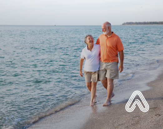Older couple walking on beach