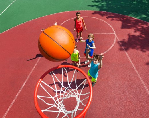 Young Children Shooting Basketball Hoops