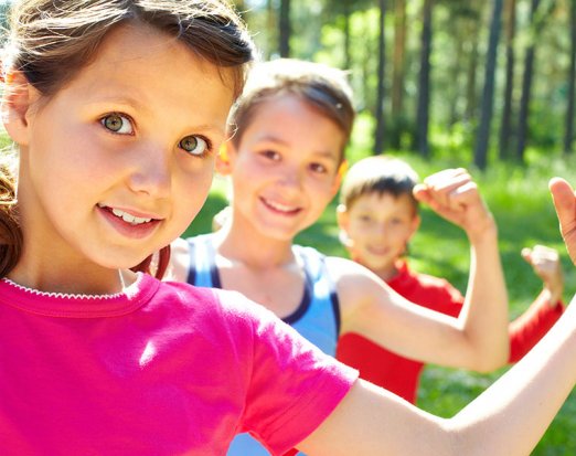 Three Children Flexing Their Biceps to Show Strength