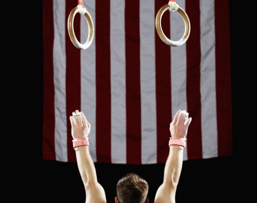 Athlete reaching for gymnast rings