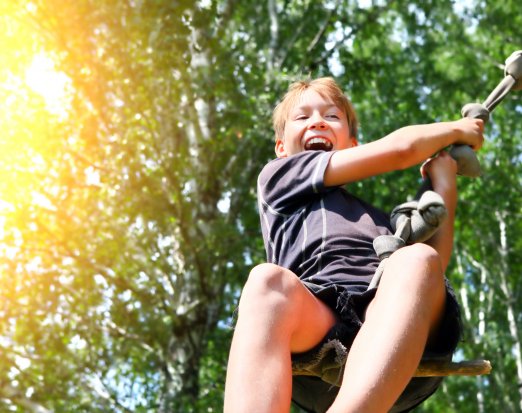 Grinning Child on a Rope Swing