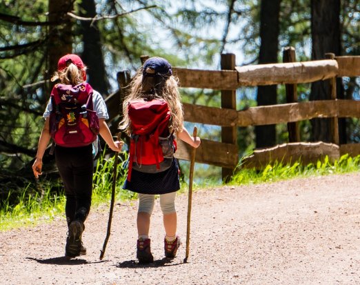 Two Young Girls with Backpacks Going on a Hike