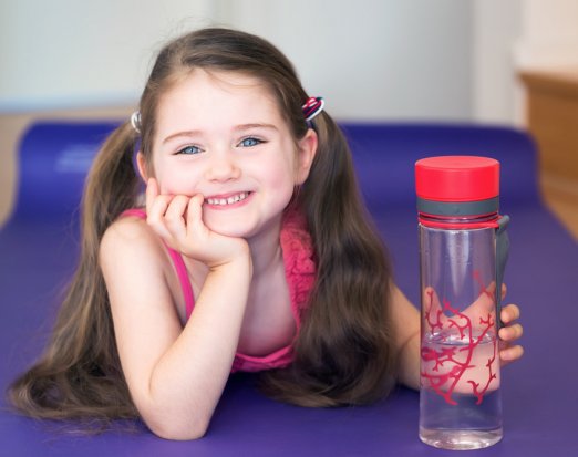 Smiling child holding a water bottle