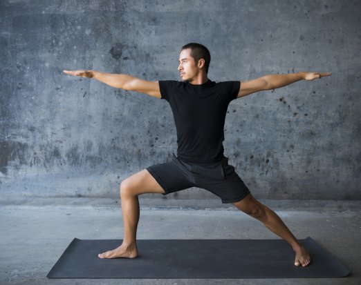 Man in Wide Legged Yoga Pose with Hands Outstretched