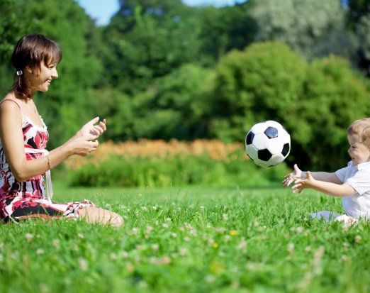 Mother and Child Playing Catch in a Field 