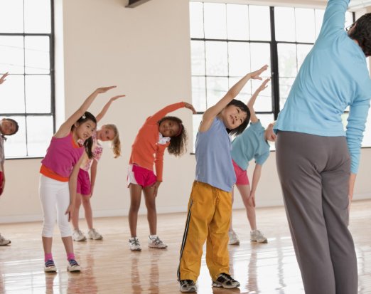 Children Doing Stretches With Their Teacher