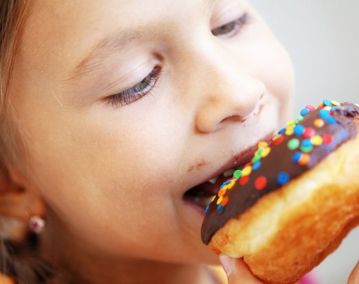 Child eating doughnut