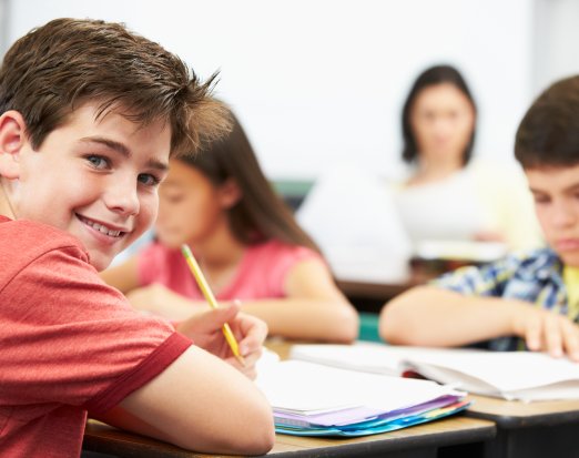 Young boy learning at school