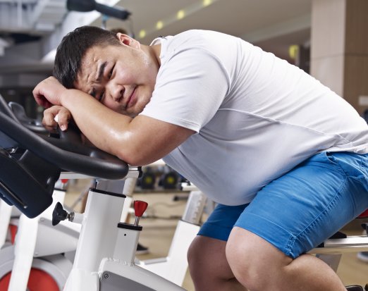 Overweight man on an exercise bike