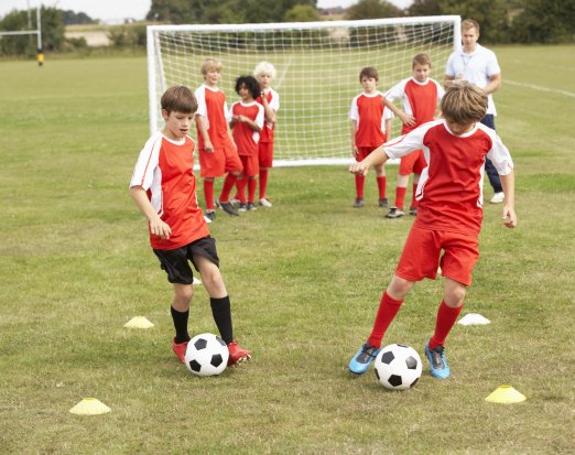 Young kids playing football