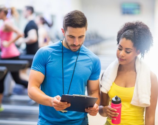 Personal Trainer showing client her results