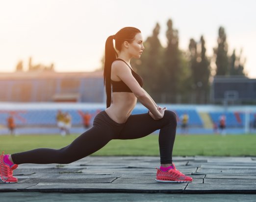 Girl squat exercising outdoors