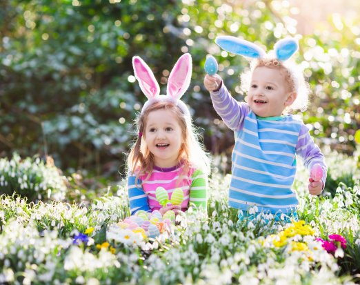 Children in forest doing Easter egg hunt