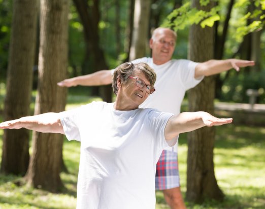 Older adults doing yoga outside