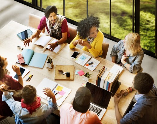 A Group of Teachers Brainstorming At a Desk