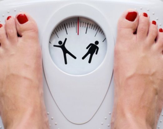 Woman weighing herself on a scale