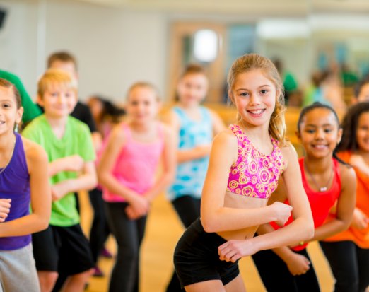 A Group of Children Smiling and Holding a Dance Pose 