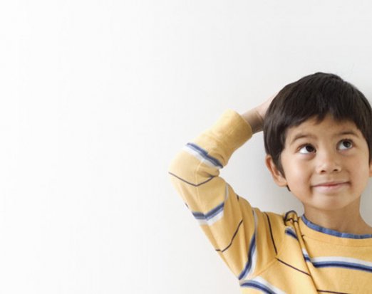 Young Boy Standing Against a Height Measurement