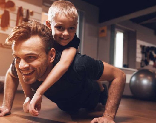 Dad and Young Son Doing Push Ups Together