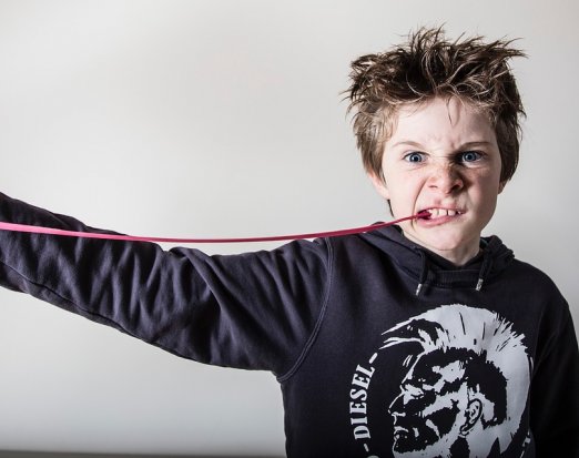 Young Boy Chewing Gum and Pulling a Fierce Face