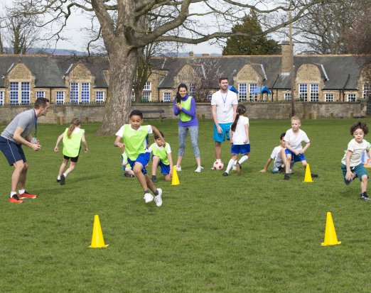 primary school kids playing football