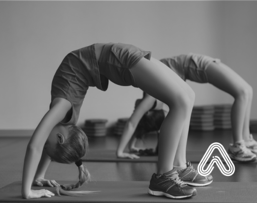 Two Young Girls Twisting Into a Crab Stance 