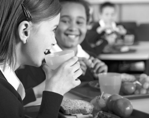 Two Young People Eating a Healthy School Lunch