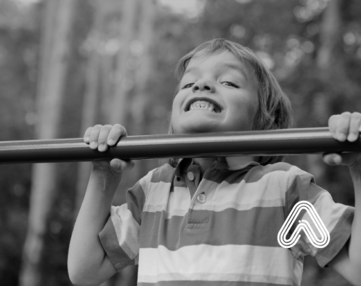 Child doing pull up on bar
