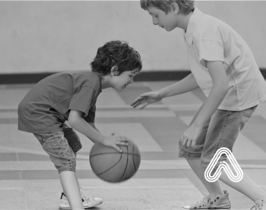Young children playing basket ball
