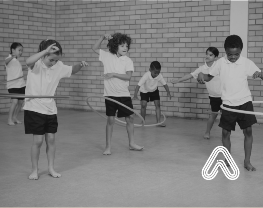 Kids playing with hula hoops in school