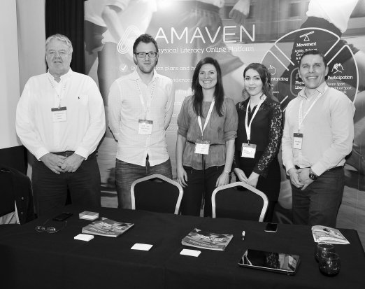 members of Amaven standing at conference 