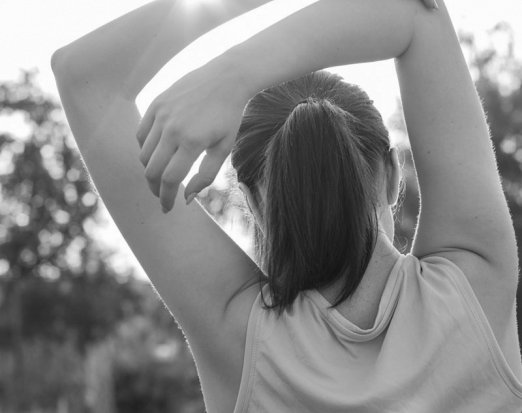 Woman stretching in the sunshine