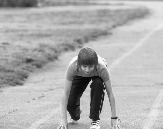 Child about to start running on a track