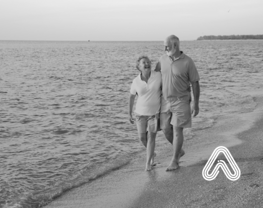 Older couple walking on beach