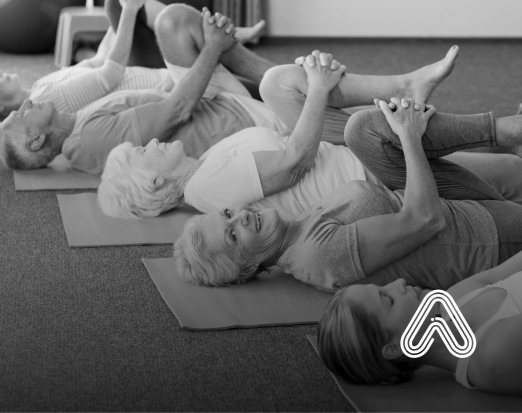 older adults doing exercise on a matt