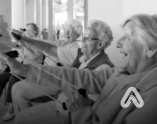 Group of older people sat down doing exercises