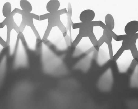 Paper people casting a shadow