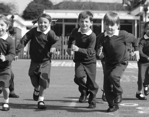 Primary School Children Running in the Playground